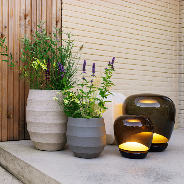 Cove planters from the Strata family, styled outdoors with greenery.