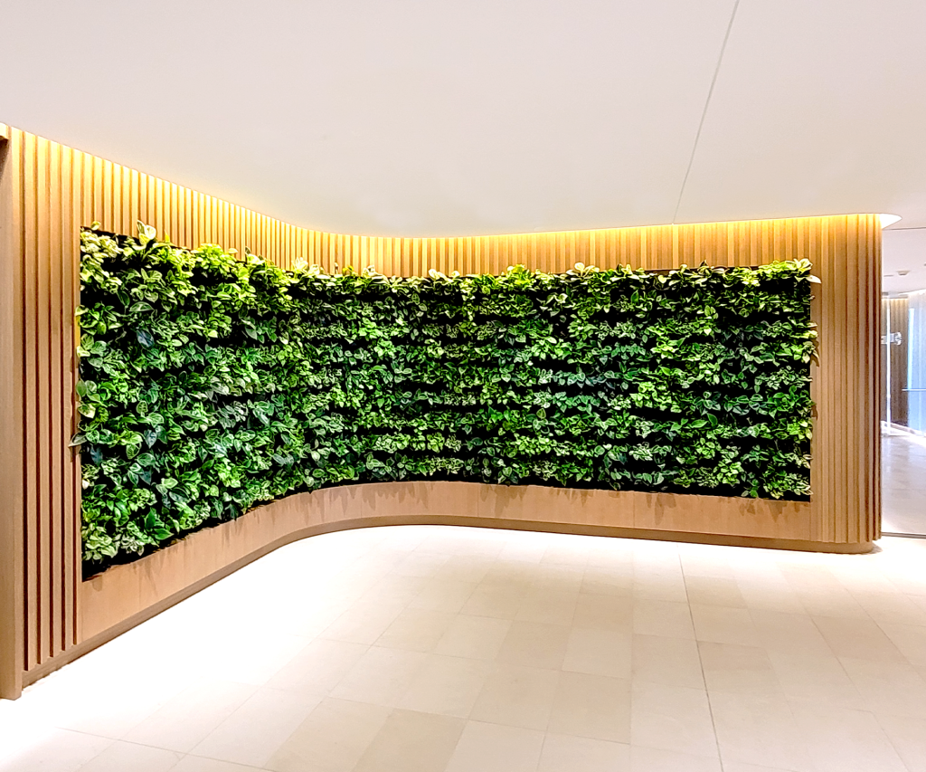 Curved POD Living Wall integrated into custom millwork for a confidential workplace project by Green Oasis.