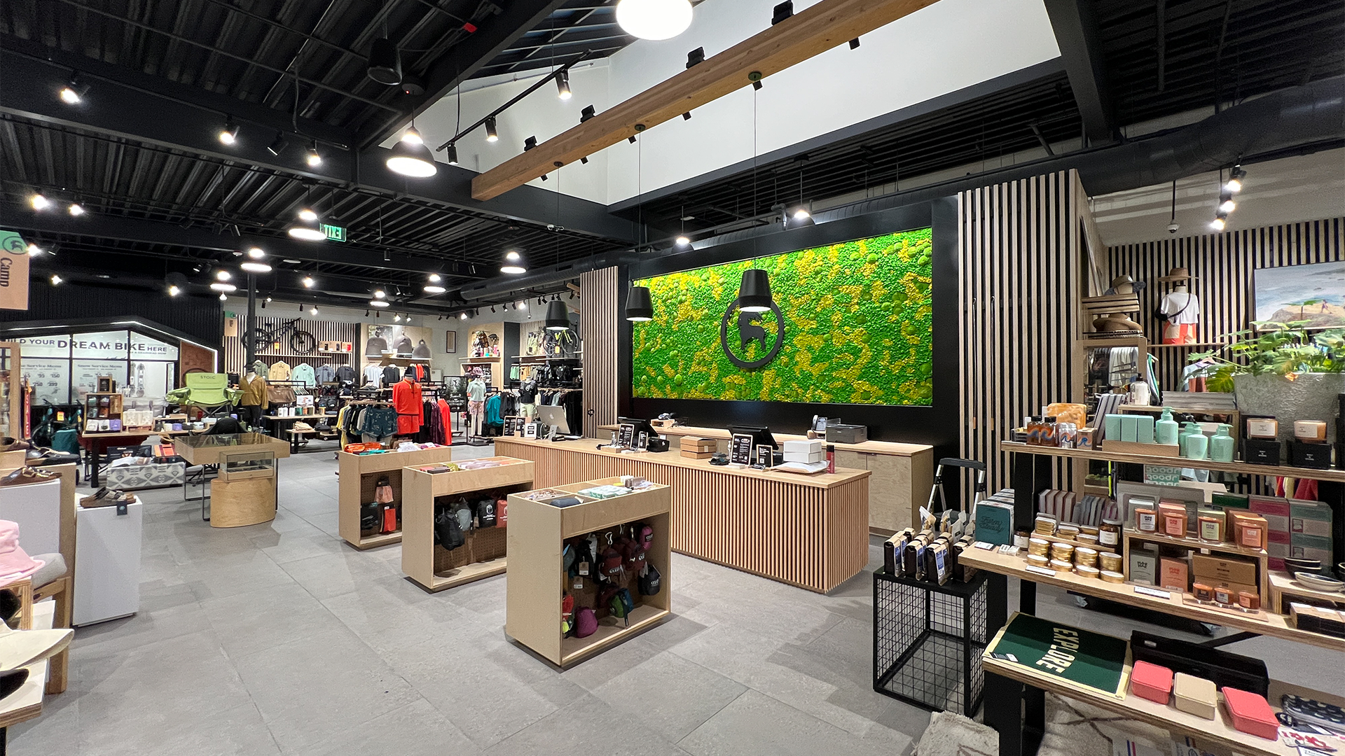 Preserved moss wall feature inside Backcountry retail store surrounded by product displays.