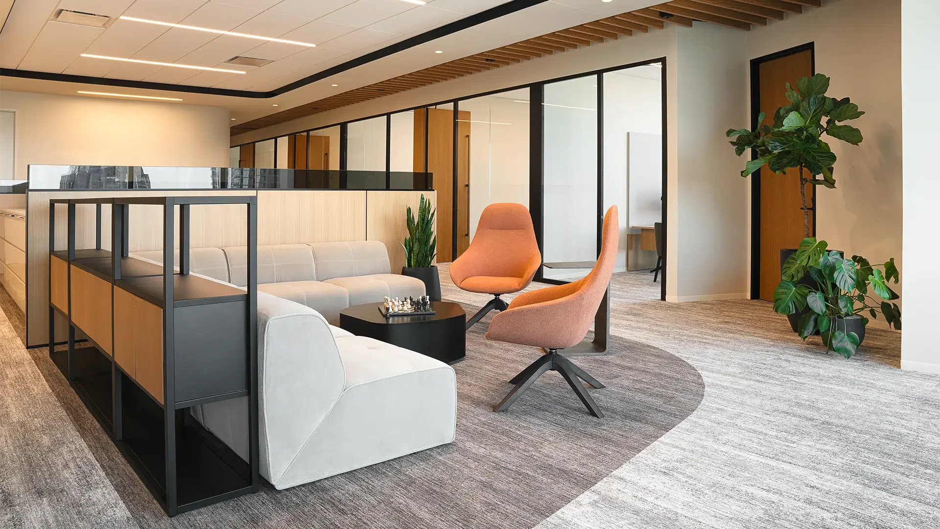 Modern office lounge with interior planters and greenery at an Austin law firm.